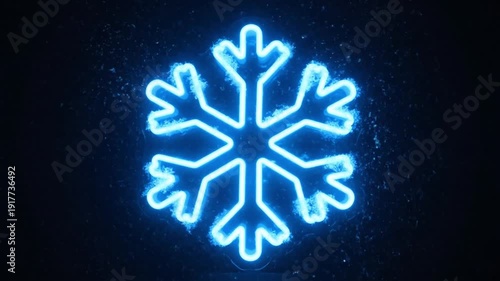 Glowing blue neon snowflake on dark background