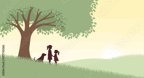 Two children and their dog in silhouette under a tree on a grassy hill at sunset