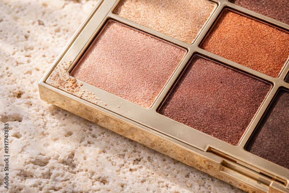 Fototapeta premium Close-up of elegant eyeshadow palette on textured surface