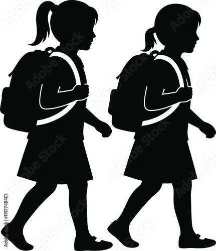 Two schoolgirls walking with backpacks on shoulders, profile view