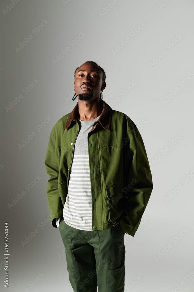 Fototapeta premium Elegant young African American man showcases style with confidence in a modern setting