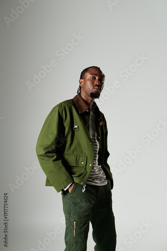 Stylish modern man stands confidently in elegant attire against a minimalist background