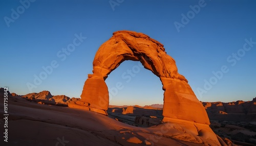 Majestic arch formation at sunset in arid desert landscape. corona arch utah