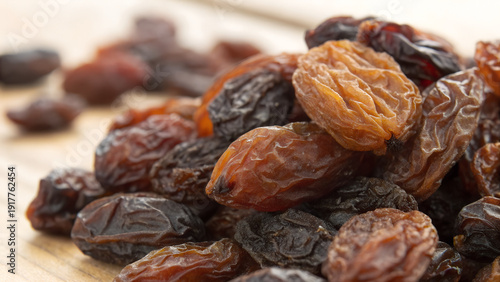 Wallpaper Mural A macro closeup of a heap of organic dried raisins and sweet grapes isolated on a white plate as a delicious natural brown snack ingredient Torontodigital.ca