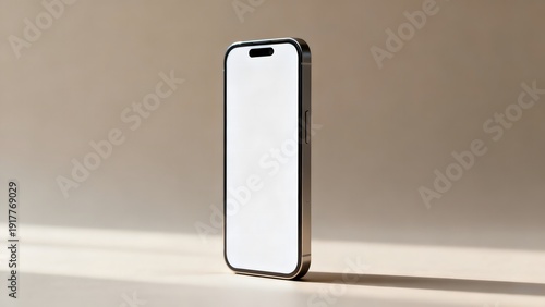 A sleek smartphone with a blank white screen standing upright on a beige surface against a neutral background with soft lighting.