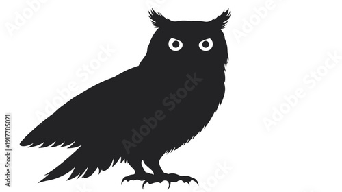 Silhouette of an owl perched on a branch at dusk