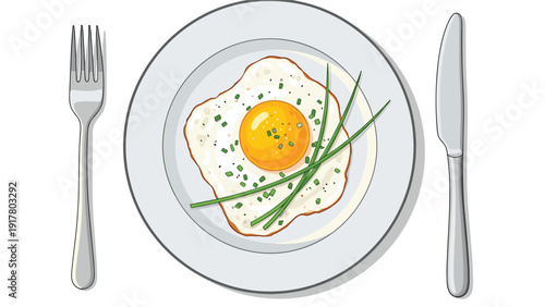 Delicious fried egg seasoned with chopped chives and pepper served on a white ceramic plate with a silver fork and knife.