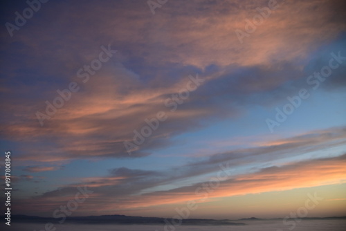stunning view of a sunrise between fog ans sky