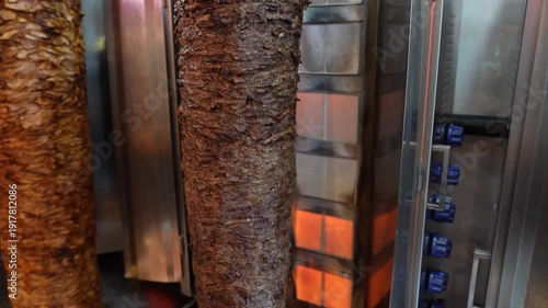 Shawarma Meat Rotating on Vertical Grill – Traditional Middle Eastern Food