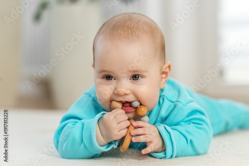 Baby Chewing Wooden Teether Toy at Home. Baby care