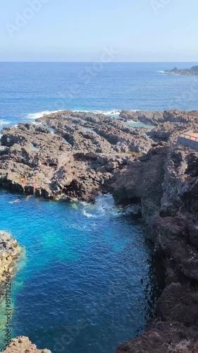 Rocky coastline and turquoise waters with Mount Teide in the background, Costa El Sauzal, Tenerife, Canary Islands, Spain