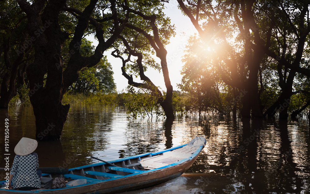 Naklejka premium Tonle Sap lake, Siem reap Province, Cambodia. Fisherman in his boat, Floating village of Kompong Phluk, Cambodia.