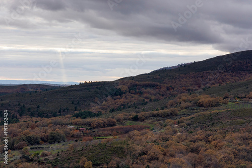 A cloudy sky with a mountain in the background