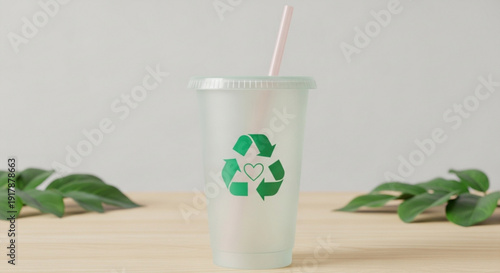 Recyclable Plastic Cup with Green Recycling Symbol and Straw on Wooden Table