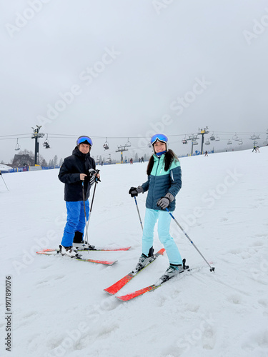 A man and woman on a ski slope in the Polish Tatra Mountains. Polana Szymoszkowa