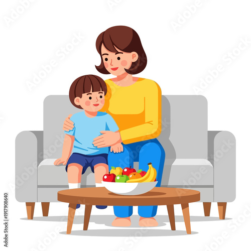 Mother and son sitting on sofa with fruit bowl on coffee table, happy family moment