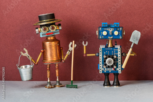 Fotografie Robot gardeners with watering can, rake and shovel