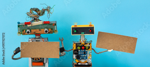 Whimsical robot pair holding empty signs. Blank mockup concept, advertisement banner template