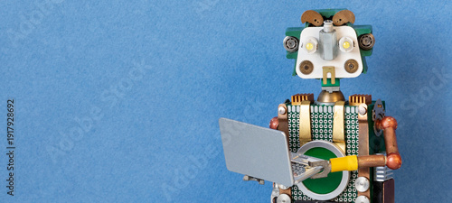 Kind green toy robot operator holding open notebook, blue background with text placeholder. Digital concept, advertising mockup