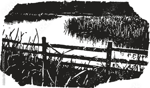 Rustic wooden fence by the marsh with tall grass and serene water reflections in black and white