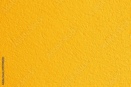 Yellow color concrete wall texture for background and design.