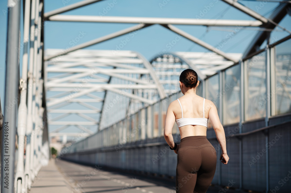 Obraz premium Fitness Woman Running on Bridge