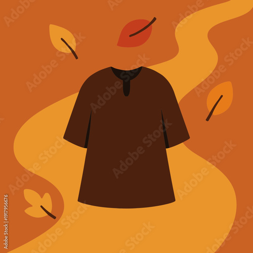 A simple tunic or cloak laid flat on a path with leaves