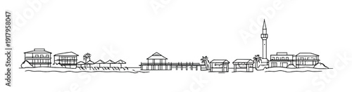 Coastal buildings and pier along a shoreline with minaret