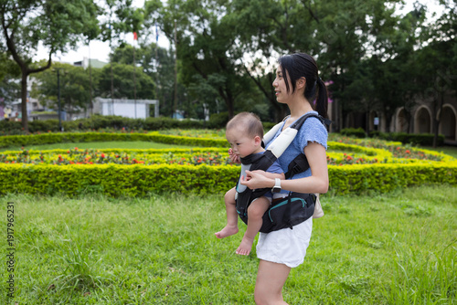 Photos Mother carry baby with carrier at park