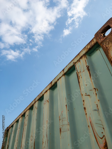 Old Rusted Shipping Container Against Blue Sky.