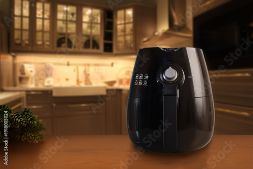 Fotografie modern black deep fryer or oil free fryer air fryer appliance is on wooden table