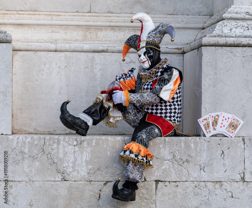 Obraz na plátně Man dressed up as a joker jester poses for the camera on San Giorgio island, photographed during the annual Venice Carnival, Italy, in Febrary 2026