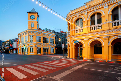 The Clock Tower, the most famous landmark in Phuket Old Town. Ancient buildings in the Sino-Portuguese style in Phuket,Thailand. Yellow old buildings in Phuket,Thailand.