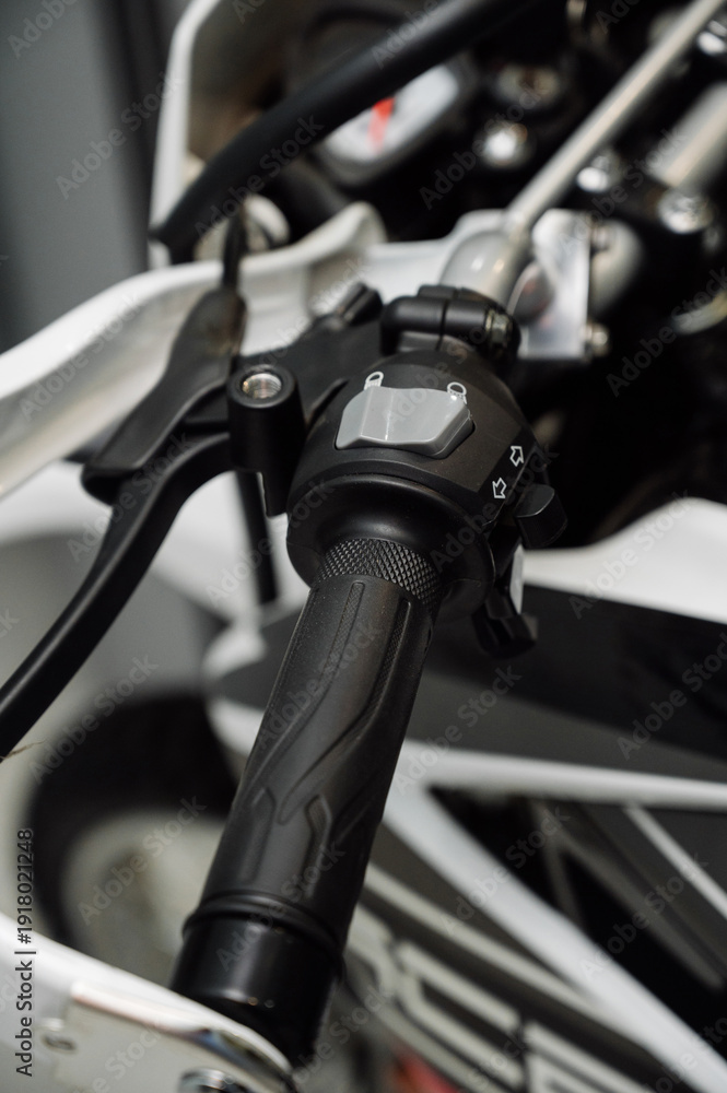Fototapeta premium Motorcycle steering wheel with ergonomic grip and switch.