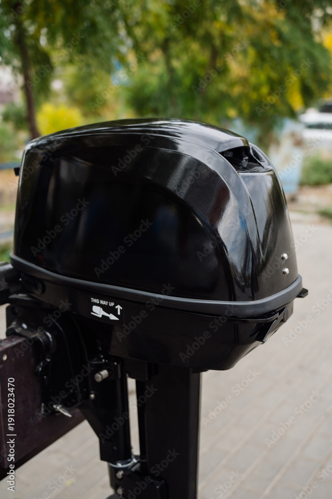 Fototapeta premium Outboard motor in the showroom: close-up of the hull and tiller.