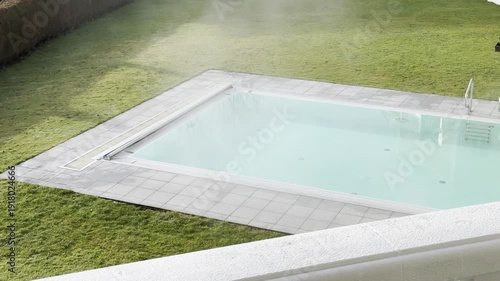steaming outdoor swimming pool at hotel spa