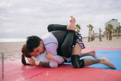 Принти на полотні Athletes grappling on beach training brazilian jiu jitsu