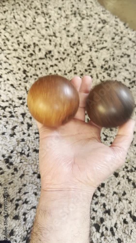 hand skillfully juggling wooden balls