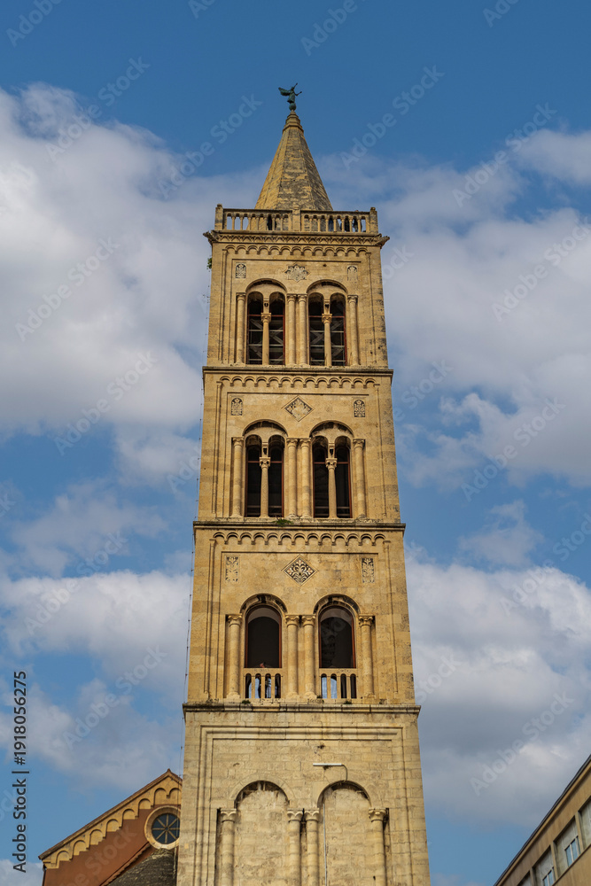 Fototapeta premium Low angle view of historic Romanesque bell tower of Cathedral of St. Anastasia Katedrala sv. Stosije in old town of Zadar, Croatia.