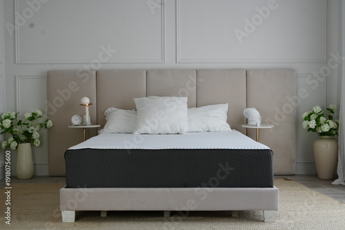 Canvastavla Elegant modern bedroom interior featuring a premium orthopedic mattress on a stylish upholstered bed frame