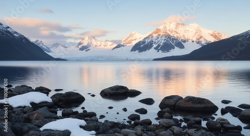 Serene glacial lake reflecting snow-capped mountains at sunrise in remote wilderness