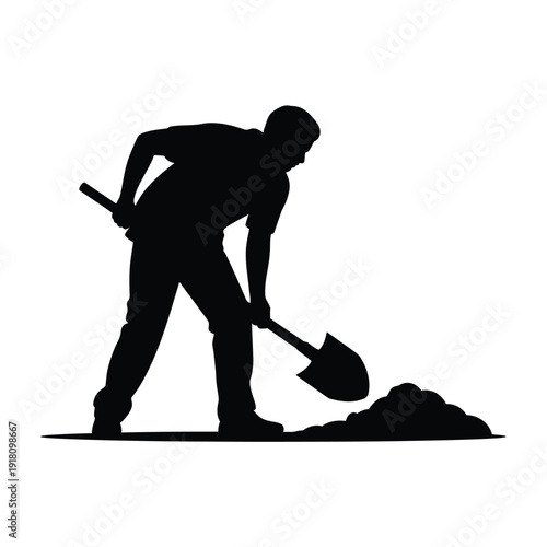 Silhouette of a man digging with a shovel in dark monochrome