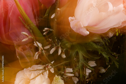 A vibrant macro photograph captures a fresh flower bouquet with motion blur and shallow depth