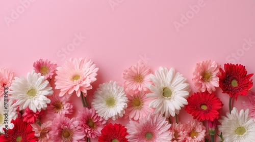 A pink and white flower arrangement with red flowers in the middle