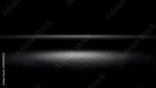 Closeup of a whisk with light reflection on a dark surface