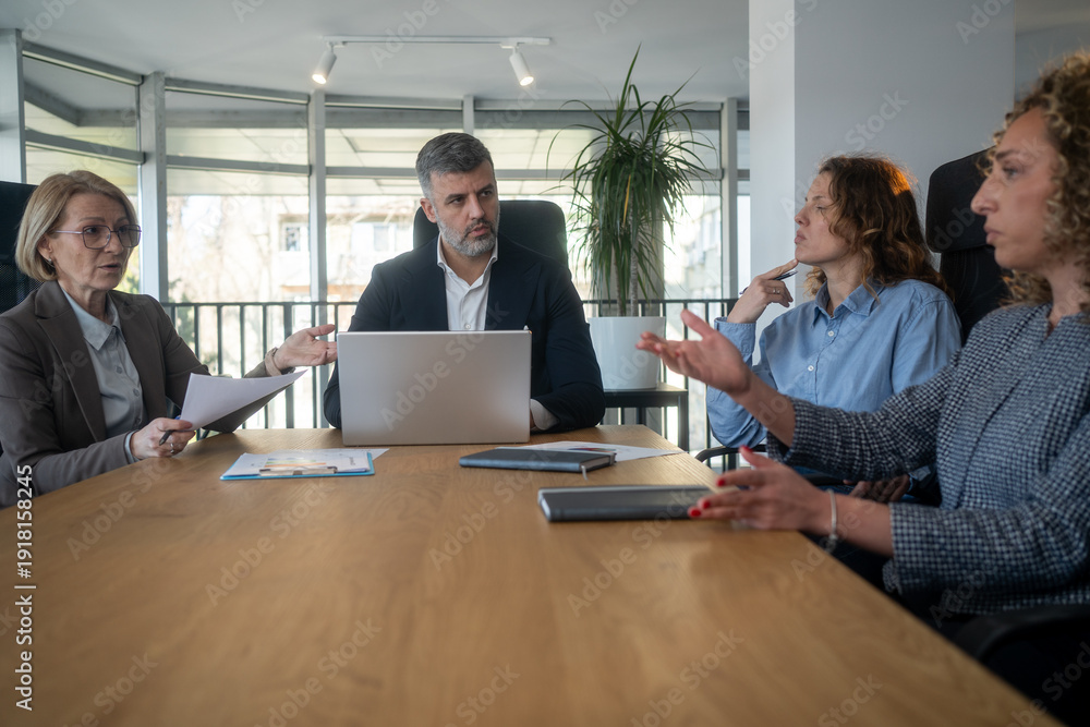 Fototapeta premium Team arguing during meeting with misunderstanding and generational gap issues