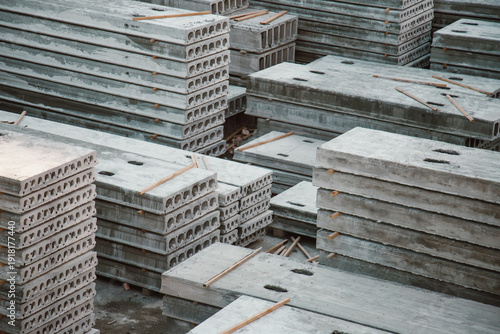 Stacks of precast reinforced concrete hollow core slabs at a construction warehouse
