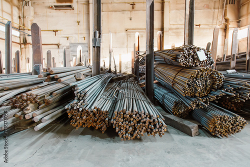 Photos Stacks of steel reinforcement bars and rebars in an industrial warehouse for con