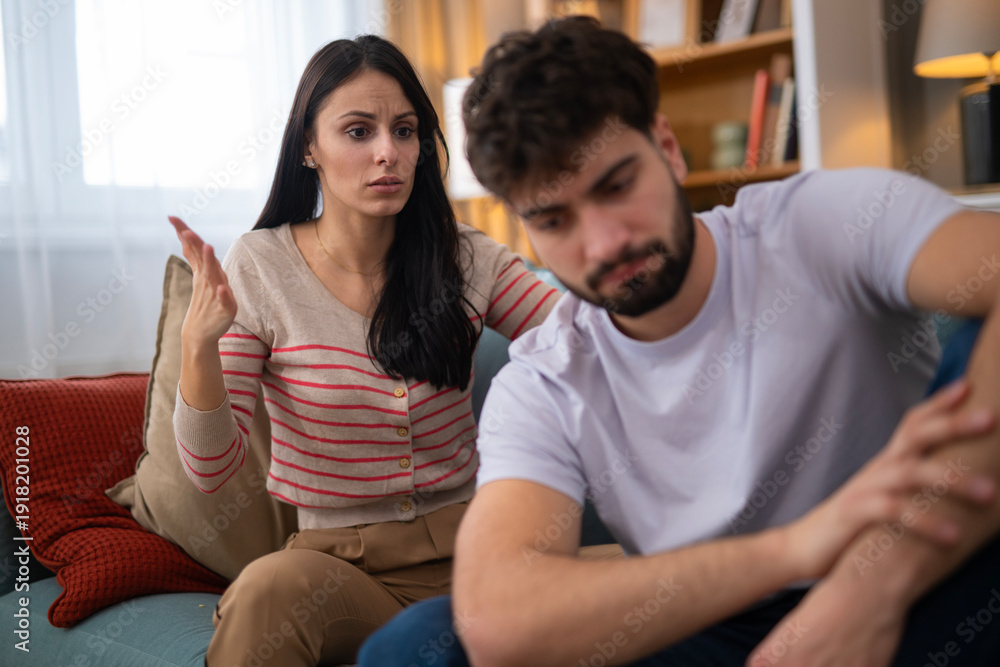 Obraz premium Couple having conflict, woman expressing anger to sad man
