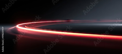 Curved bright red light streaks, glowing against a dark, blurred background